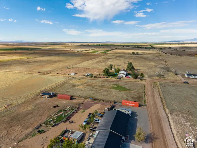 Expansive rural acreage featuring open terrain, a multi-structure property layout, and prominent mountain backdrops