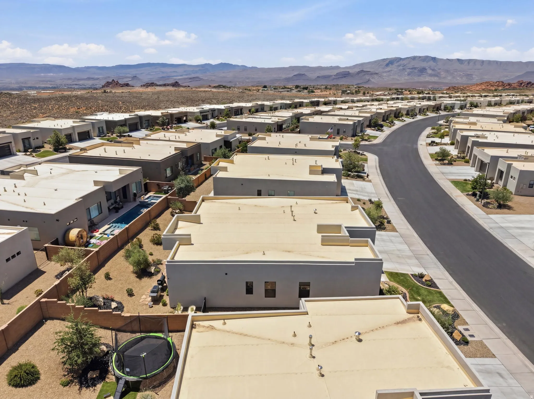 Modern desert community featuring flat-roof architecture and a paved street network