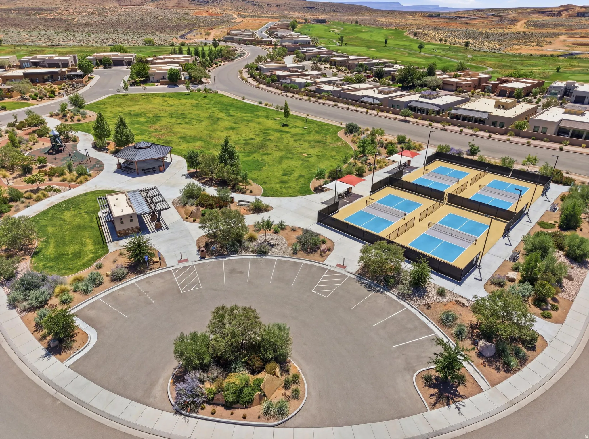 Four pickleball courts with perimeter fencing and dedicated lighting