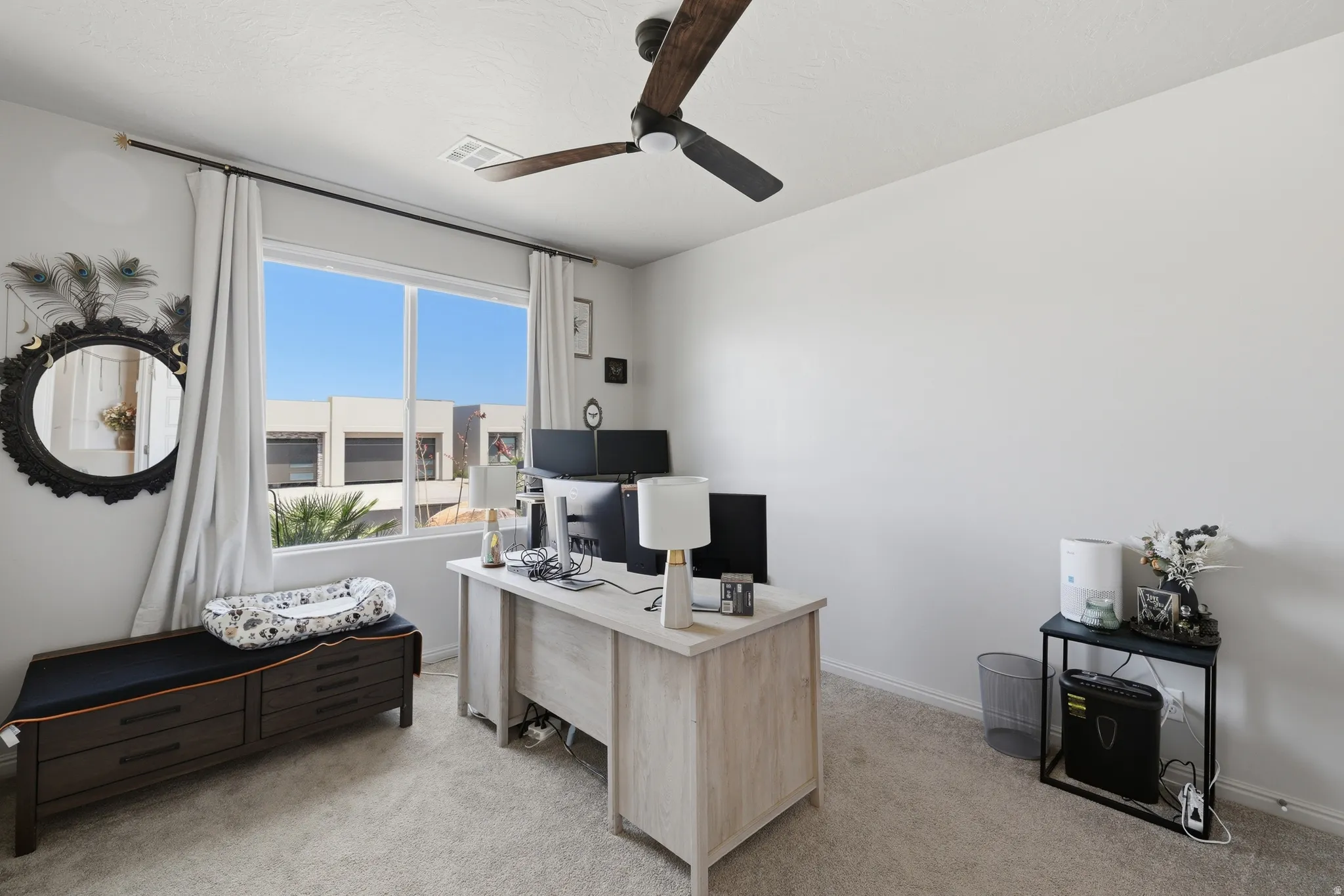 Bright room featuring light-colored carpeting and a multi-pane window