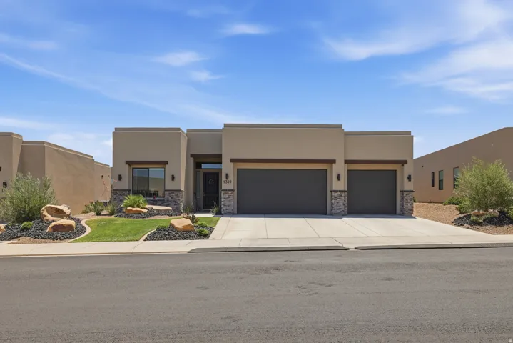 Contemporary stucco exterior with stacked stone accents
