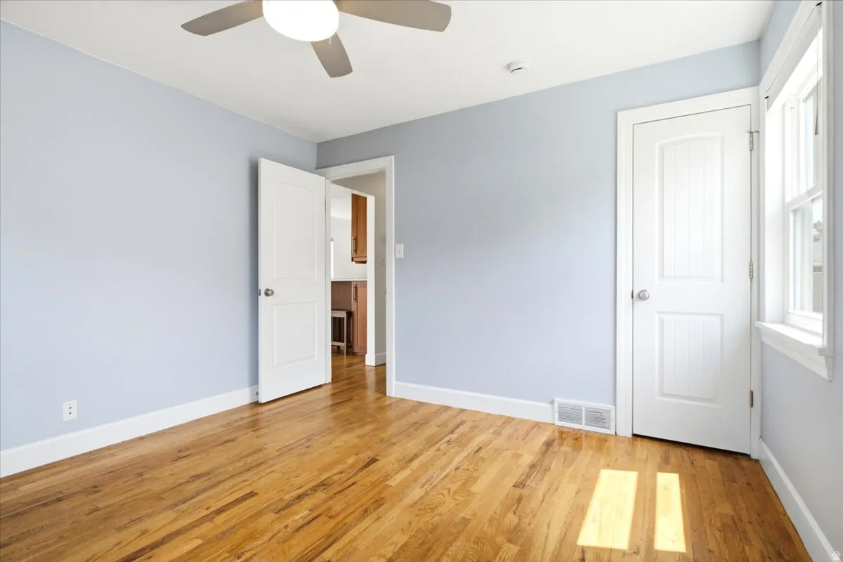 Wood-finish flooring throughout, complemented by light blue wall tones and white baseboards