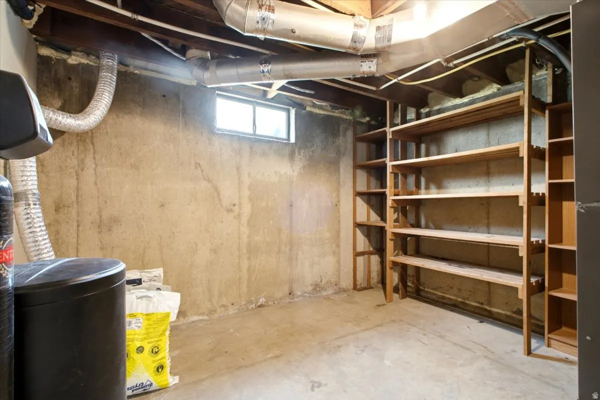 Basement storage area featuring concrete walls and flooring
