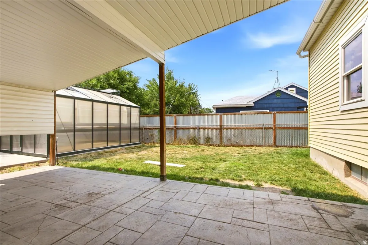 Covered patio featuring stamped concrete flooring