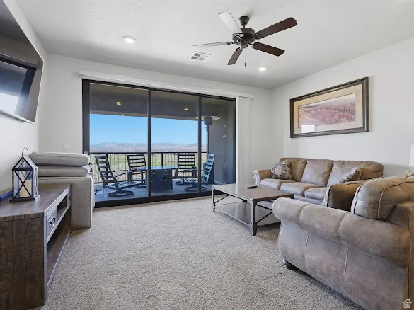 Sliding glass doors open to an outdoor balcony featuring a metal railing