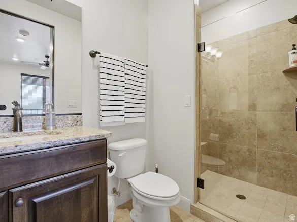 Glass-enclosed shower featuring large format wall tiles and a tiled floor