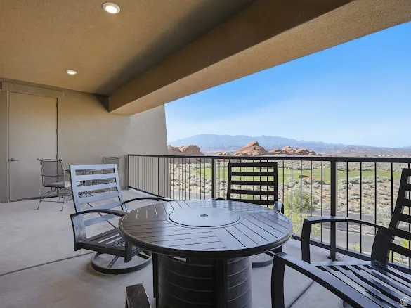 Expansive outdoor patio featuring a concrete floor, recessed lighting, and a durable metal railing