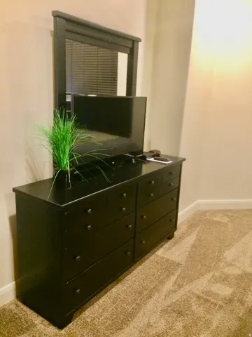 Wall-to-wall carpeting and neutral wall finishes complement the interior space