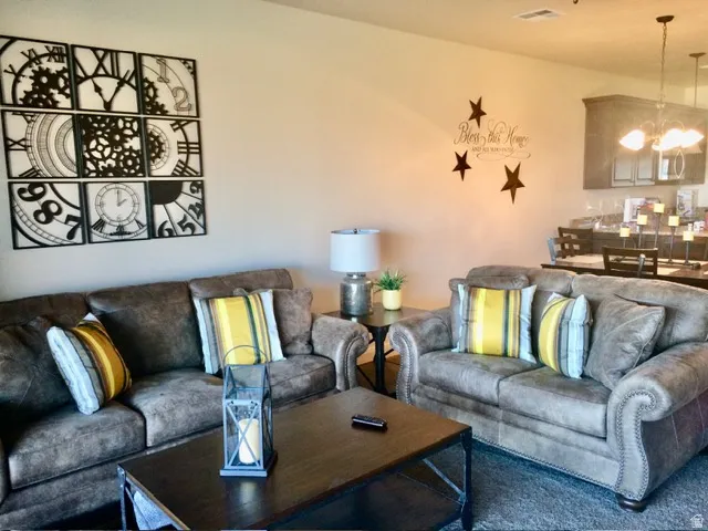 Open concept living area featuring neutral wall tones and a textured area rug