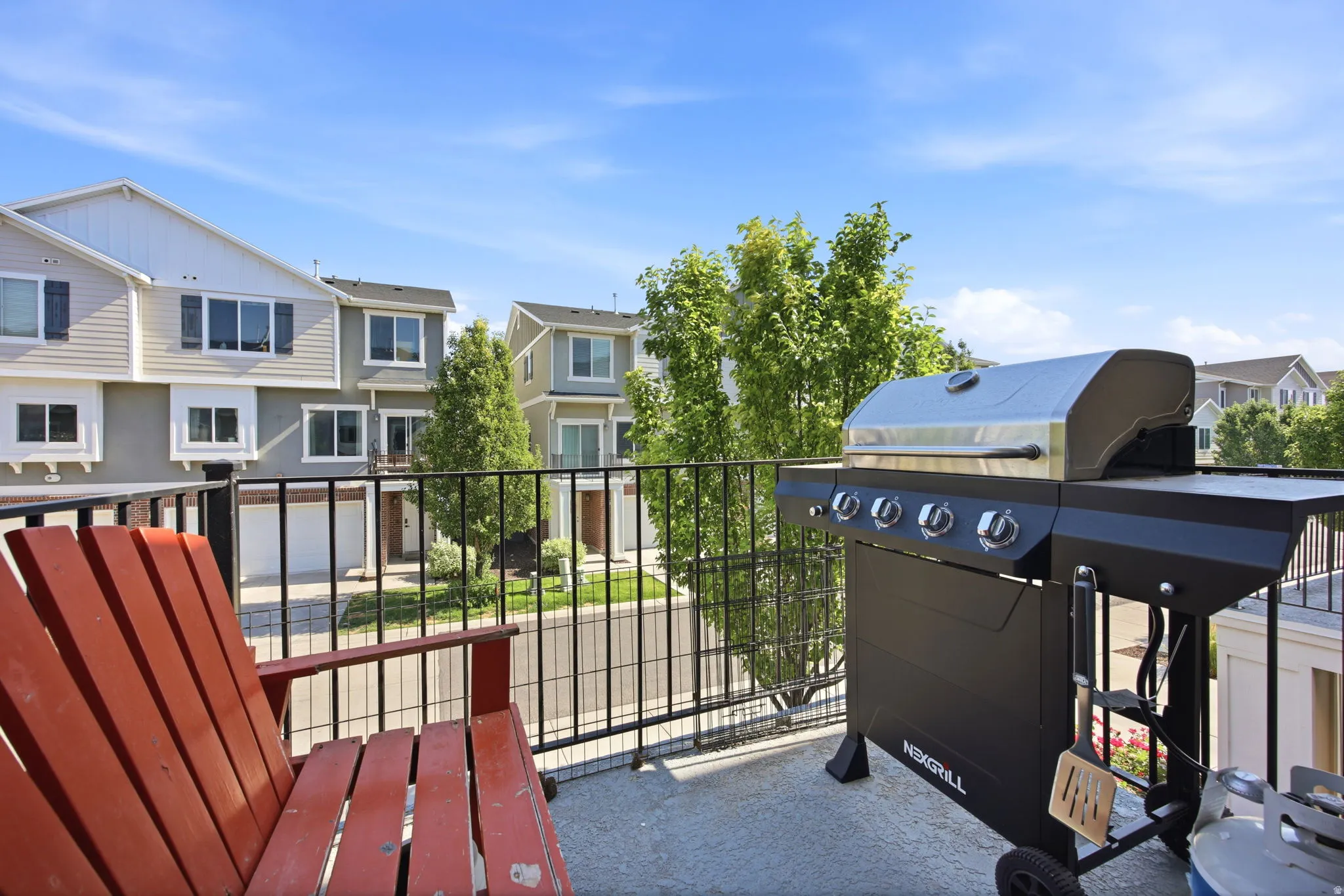 Outdoor balcony featuring black metal railings and a concrete surface