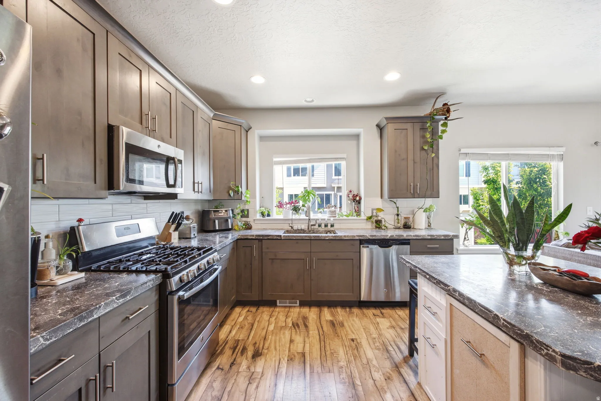 Contemporary kitchen featuring wood-finish flooring and recessed lighting