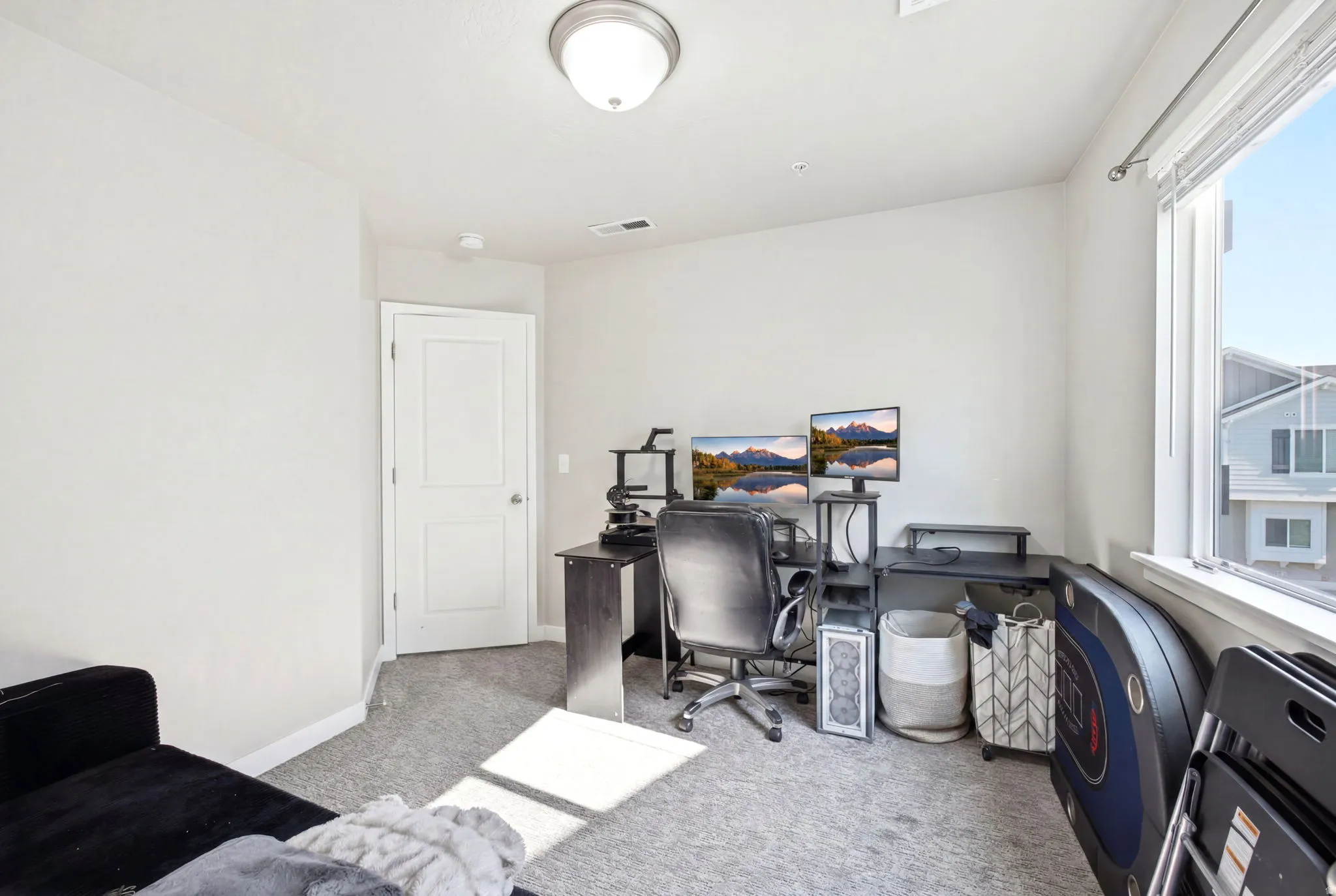 Room featuring light gray carpet flooring and white walls