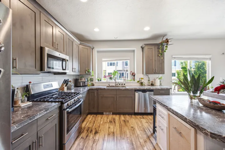 Contemporary kitchen featuring wood-finish flooring and recessed lighting