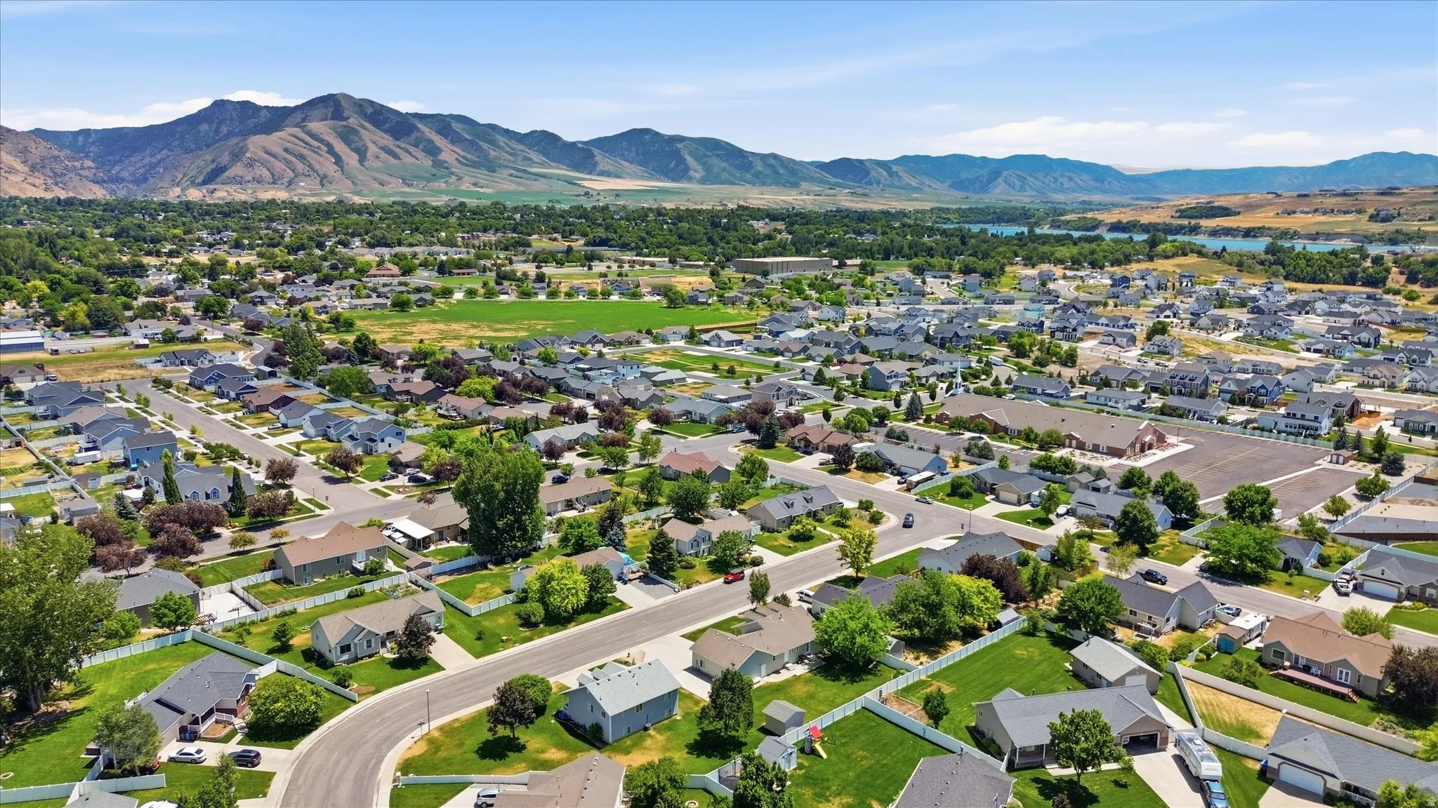 Expansive residential community with established homes, tree-lined streets, and mountain backdrop