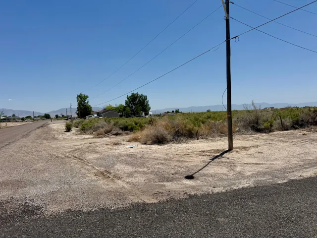 Open land parcel with visible power lines and a utility pole