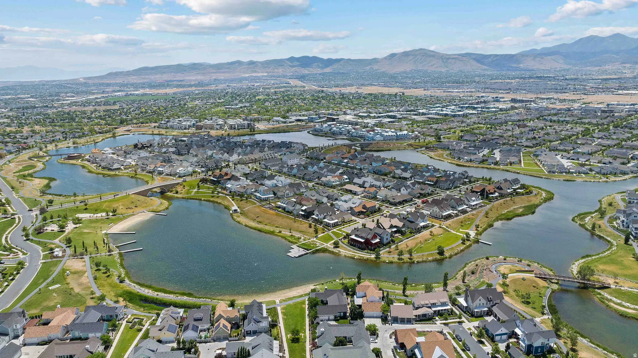 Aerial perspective showcasing a residential community with multiple lakes and surrounding green spaces