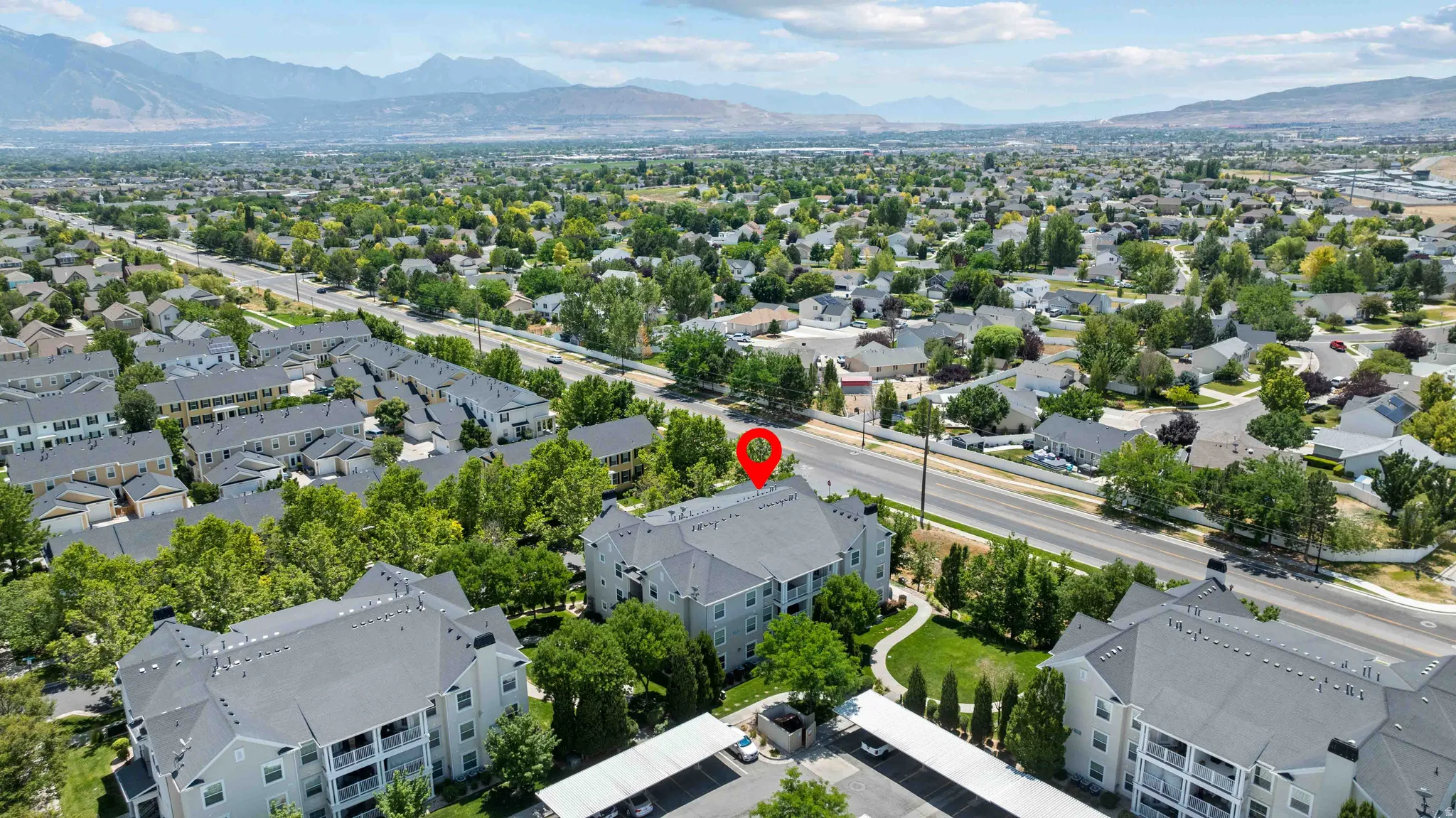 Aerial perspective highlighting the property's relationship to surrounding residential areas and distant mountain ranges