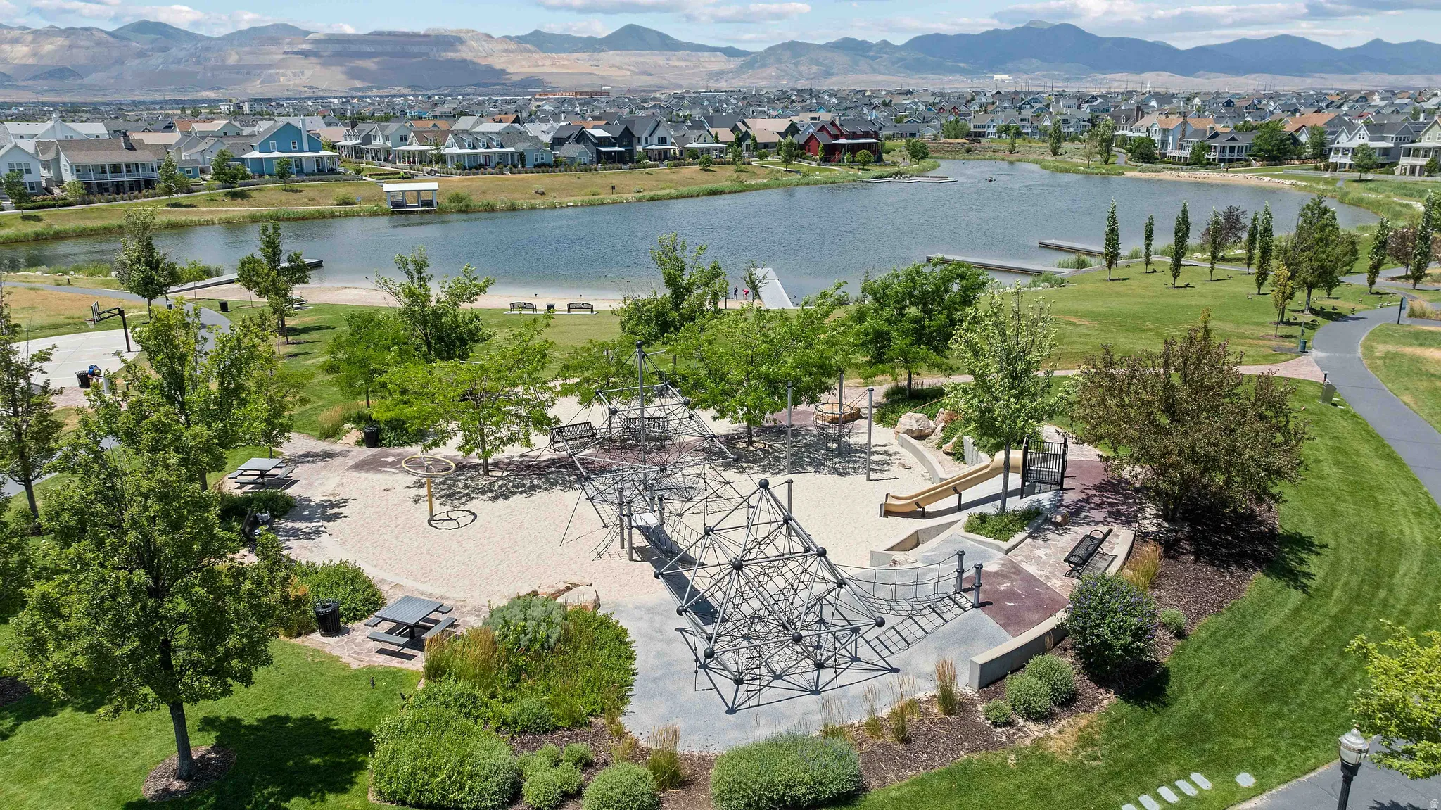 Aerial perspective showcasing a community park with a large sand-based play area