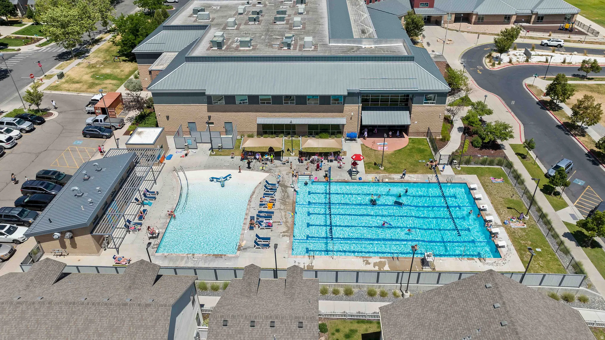 Community aquatic facility featuring a multi-lane lap pool and a separate leisure pool with beach entry