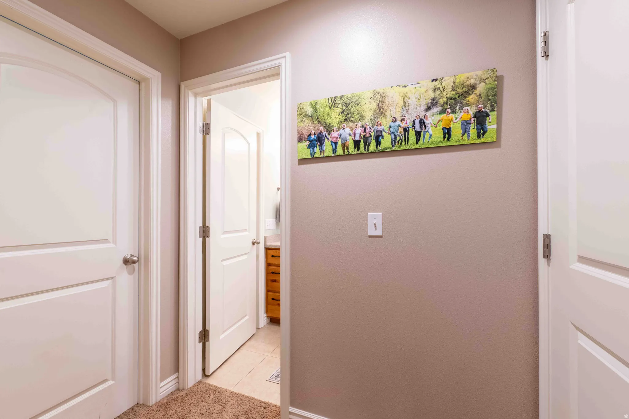 Hallway with neutral wall paint and two white paneled doors