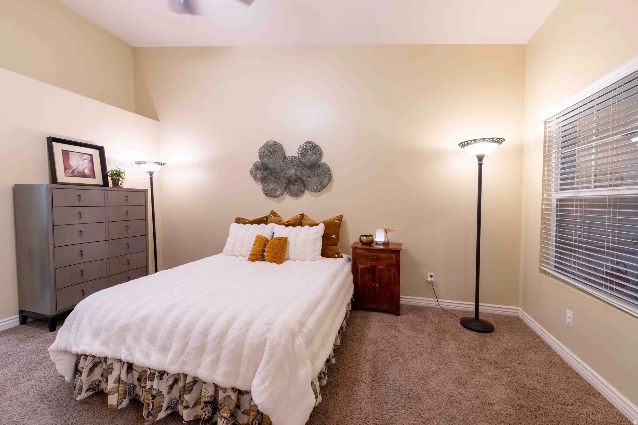Carpeted room featuring a ceiling fan, a window with blinds, and neutral wall tones