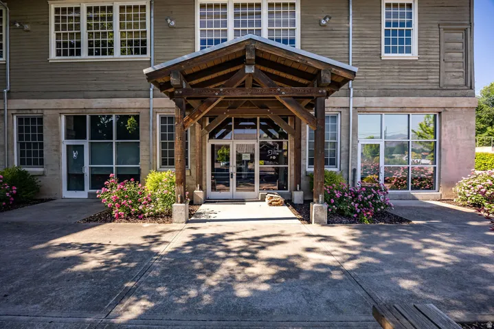 Wood-clad exterior featuring a prominent timber-frame entry canopy