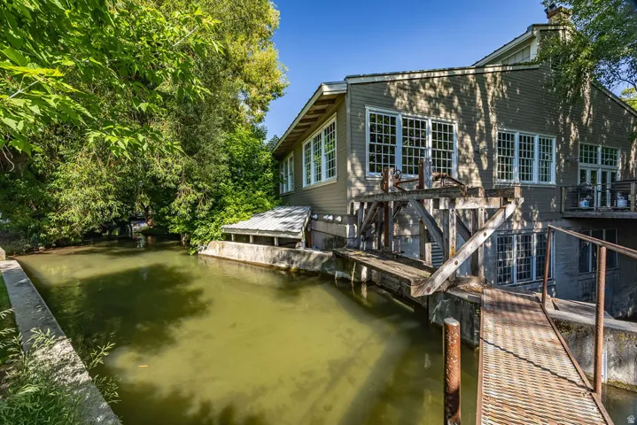 Waterfront property with wood-clad siding and extensive multi-pane windows