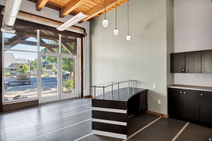 Spacious commercial interior featuring a full-glass storefront with double entry doors