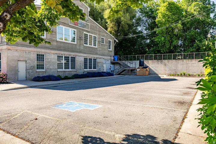 Paved parking lot featuring defined spaces and a designated accessible parking area