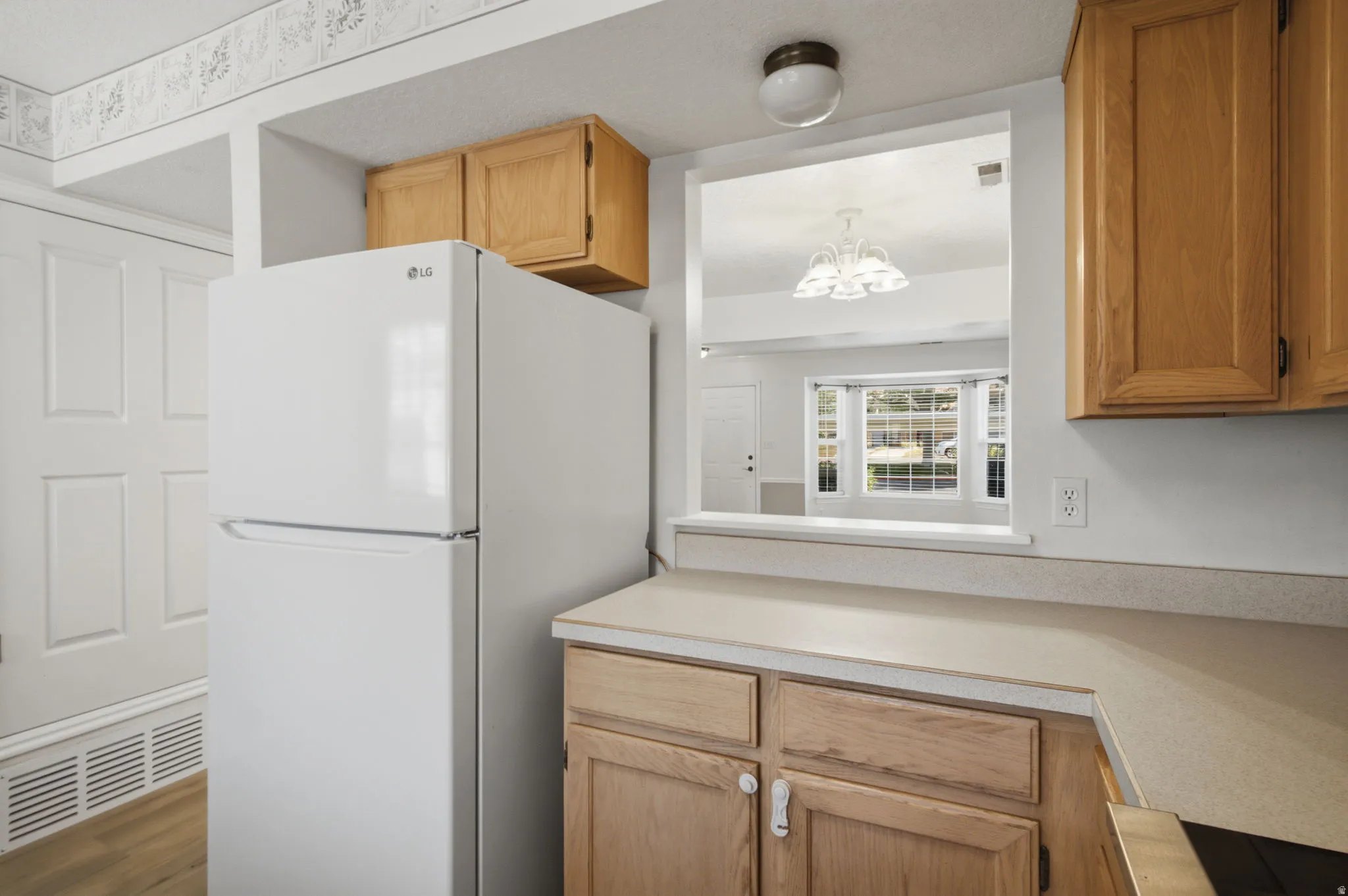 Kitchen pass-through window opening to an adjacent room