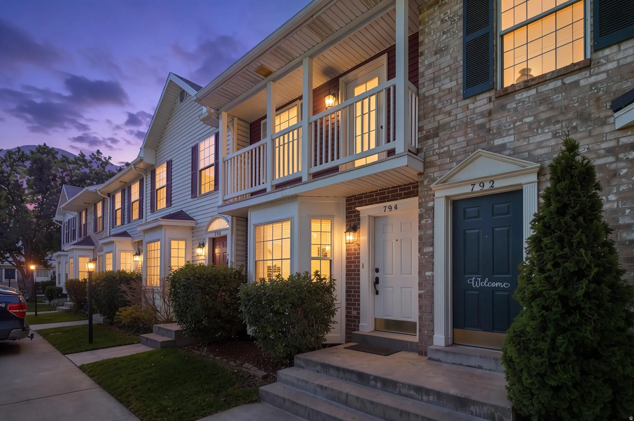 Townhome exterior featuring brick and siding facades