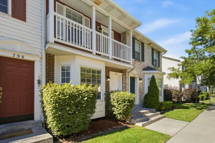 Townhome exterior featuring light brick and horizontal siding