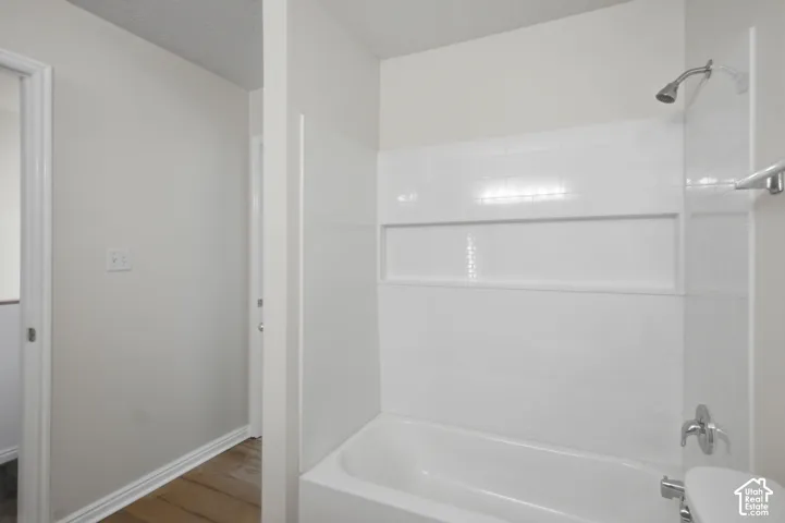 White surround with recessed niche and chrome fixtures