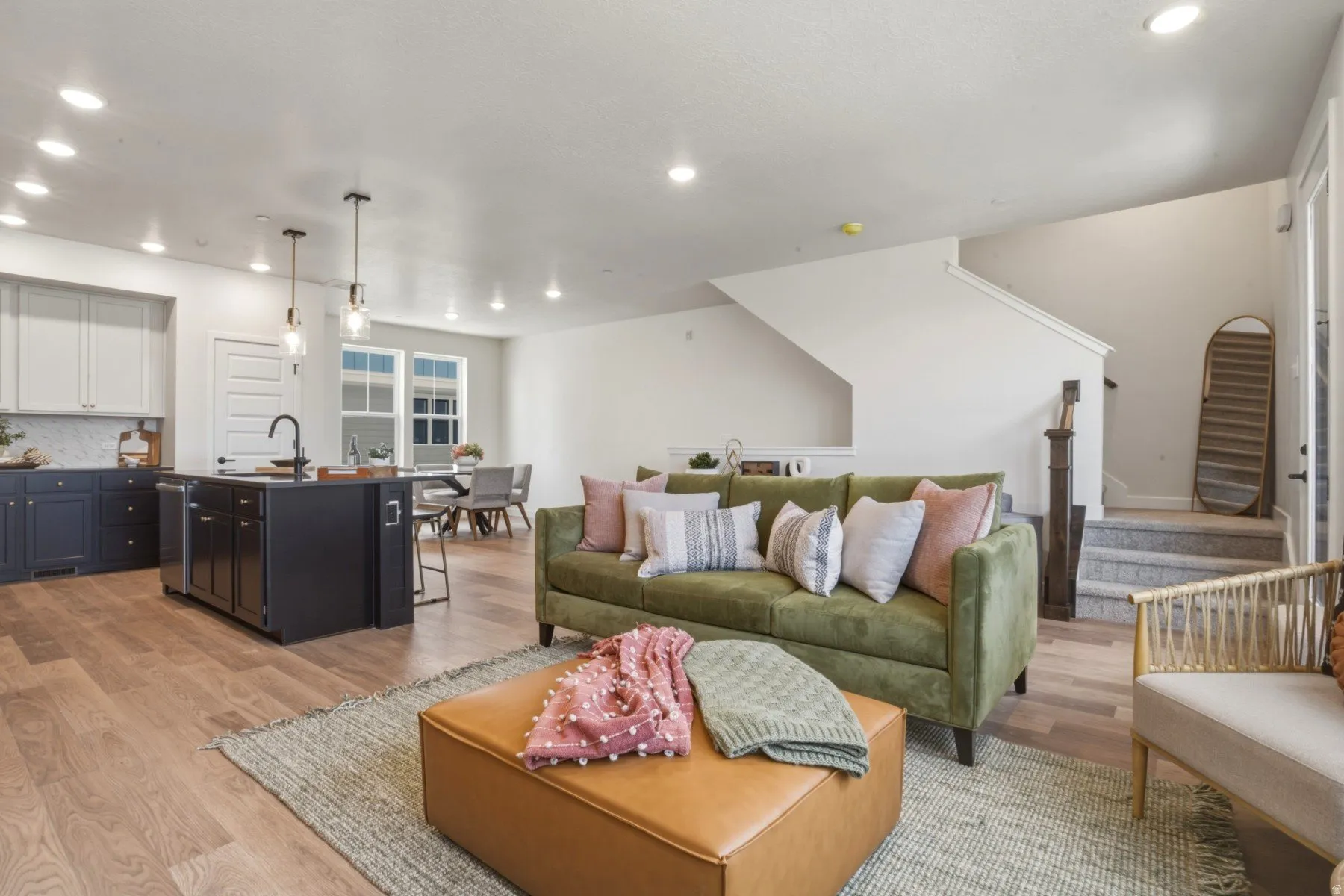 Expansive open-concept living space with wood-finish flooring