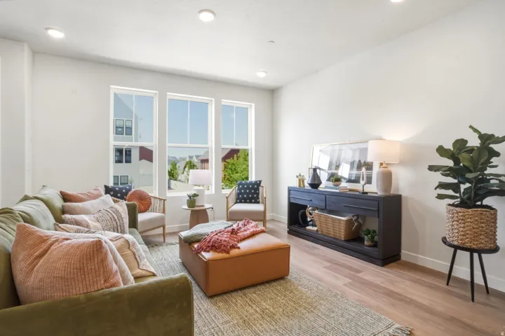 Bright living area featuring wood-finish flooring and recessed ceiling lighting