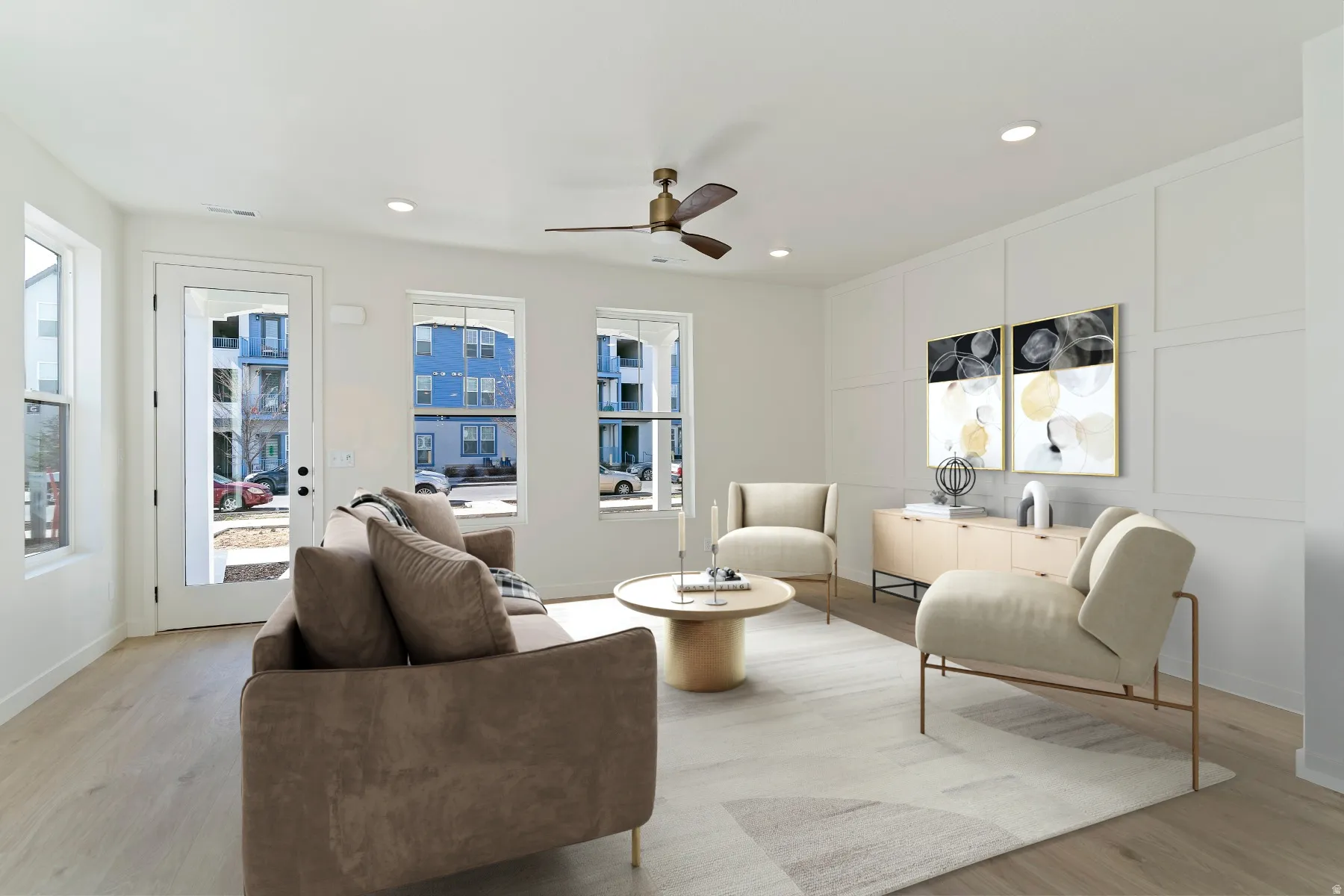Living area featuring light wood-finish flooring, recessed lighting, and a ceiling fan with integrated light