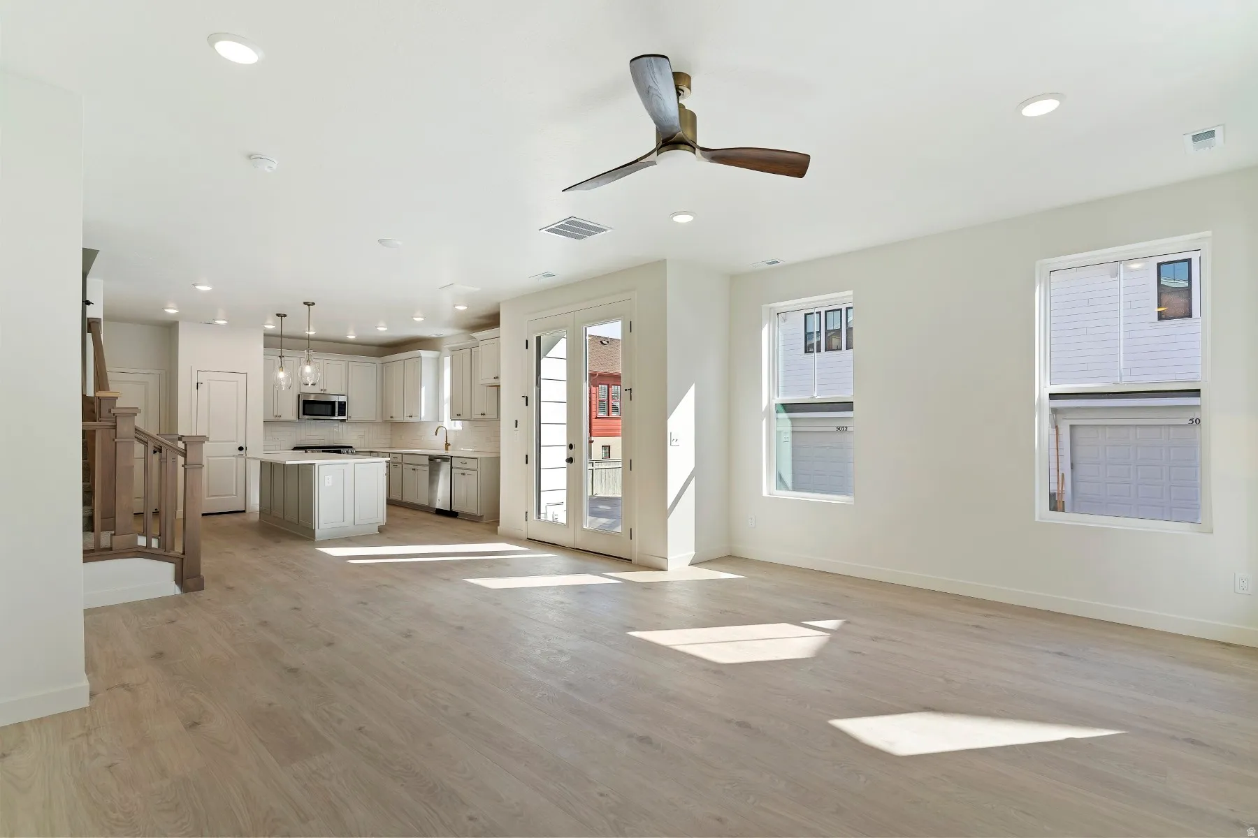 Open-concept living area with light wood-finish flooring
