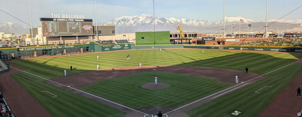 Baseball field featuring a manicured grass outfield and dirt infield