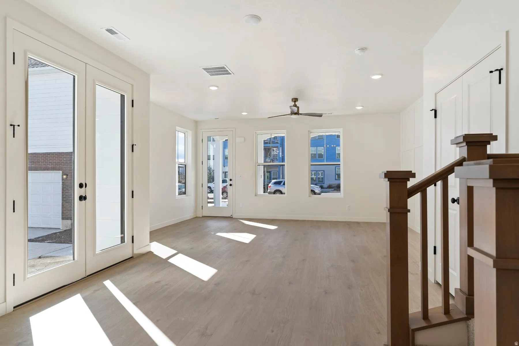 Spacious living area featuring wood-finish flooring and recessed lighting