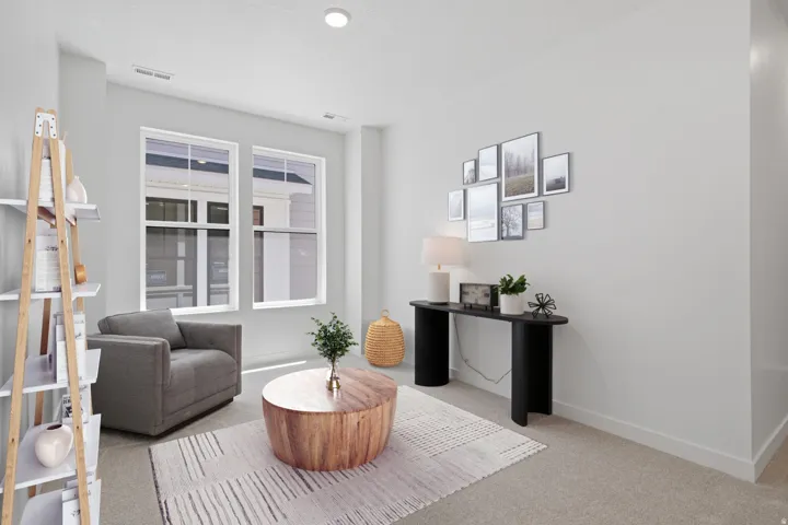 Recessed ceiling lighting, light-toned carpeting, and white wall finishes