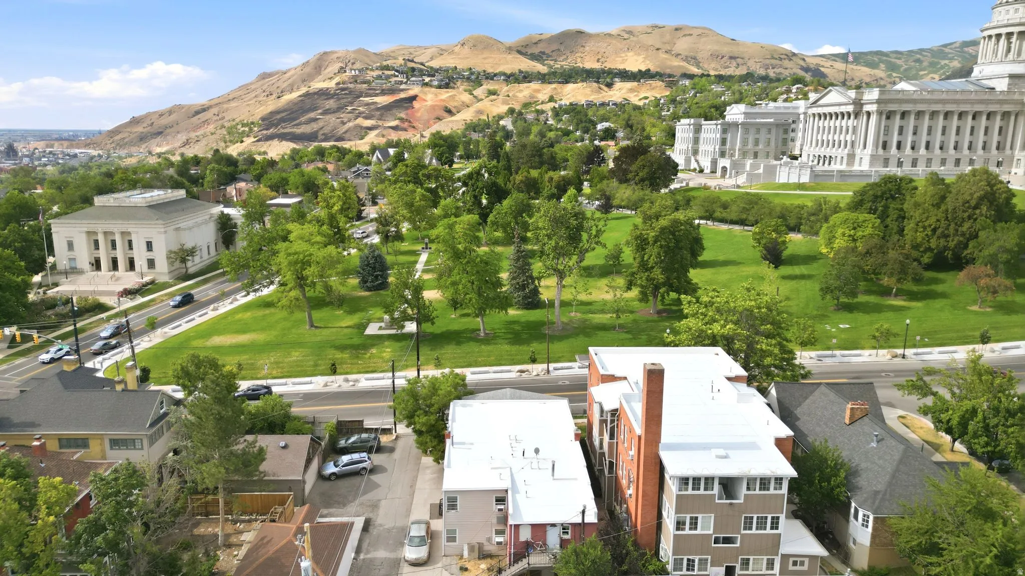 Elevated neighborhood setting showcasing mature trees, green spaces, and prominent classical architecture