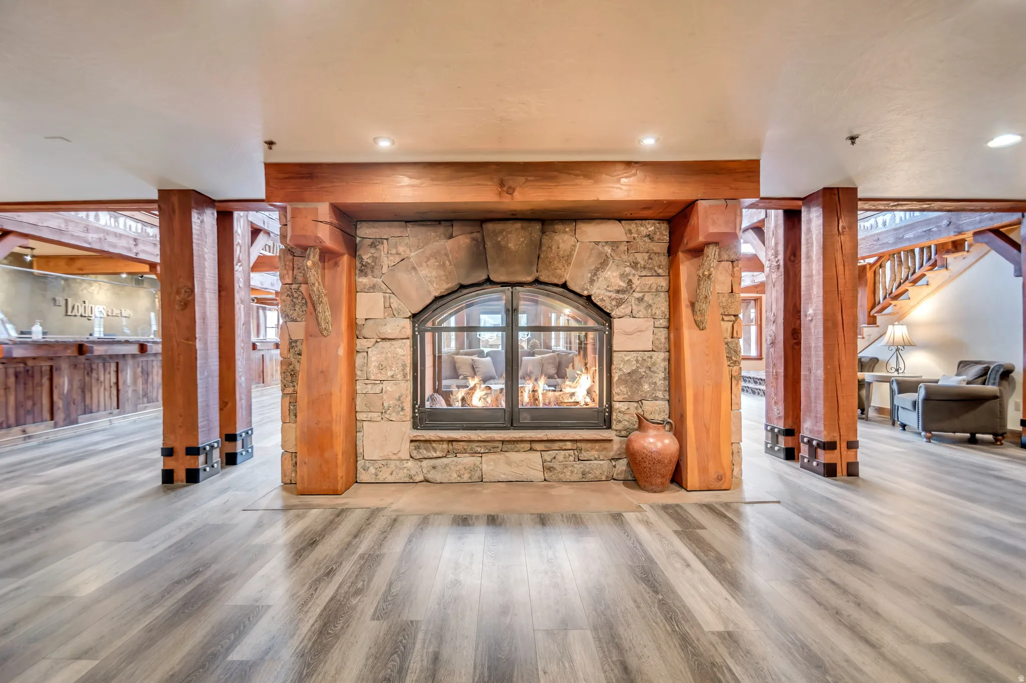 Central stone fireplace with an arched glass enclosure