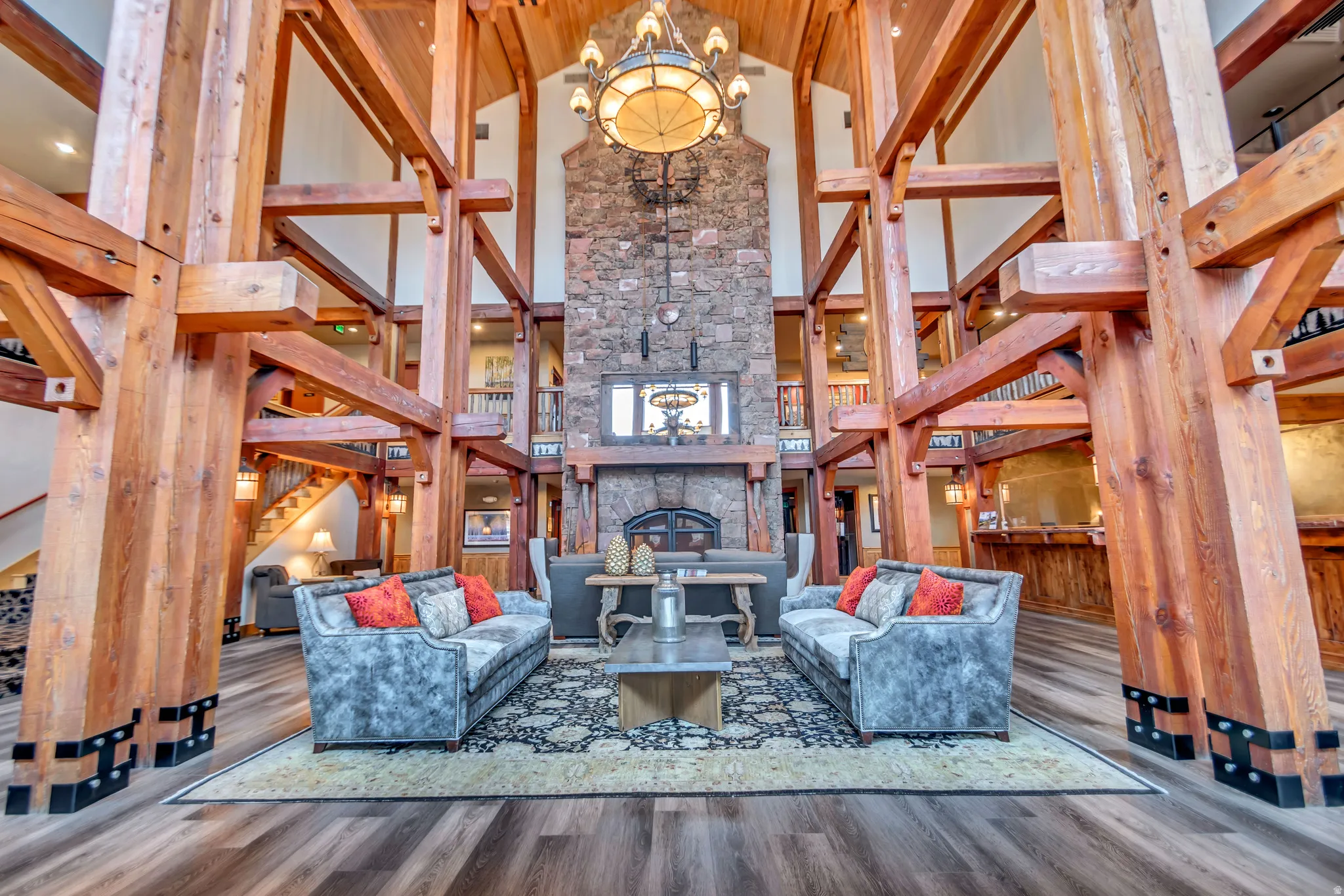 Grand vaulted ceiling with exposed timber framing and wood-finish flooring