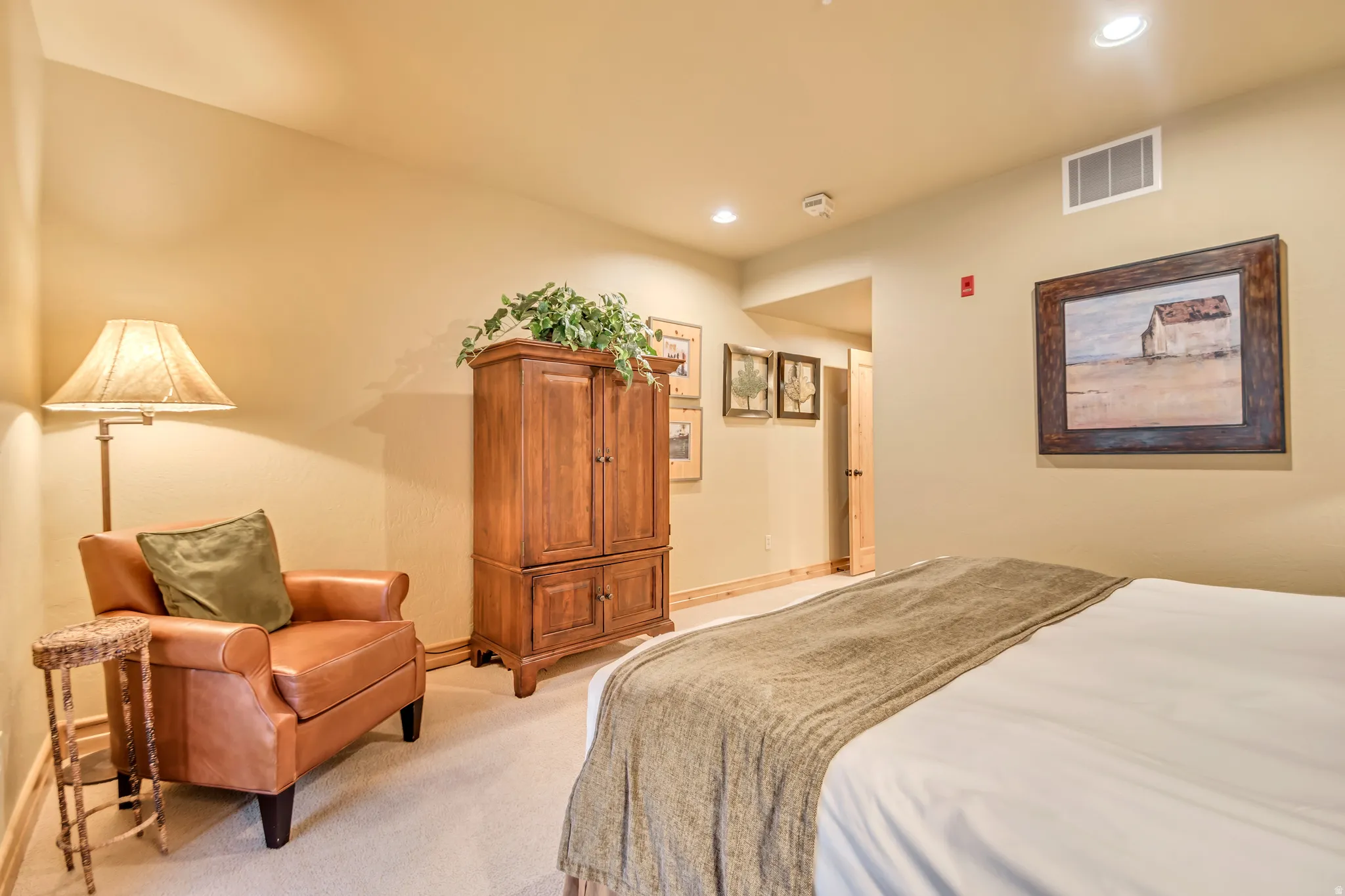 Neutral wall tones with recessed lighting and crown molding