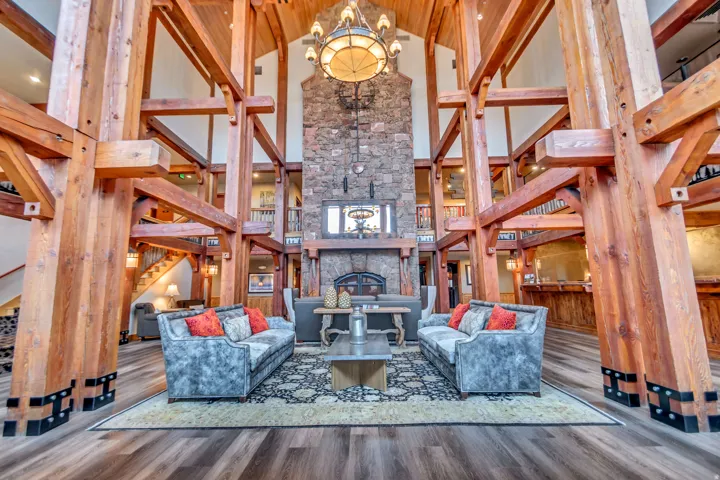 Grand vaulted ceiling with exposed timber framing and wood-finish flooring