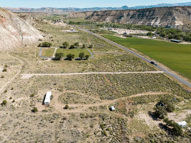 Expansive land parcel featuring diverse topography, including a flat, open area and natural vegetation