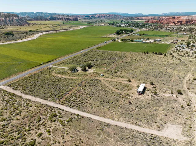 Expansive parcel featuring a mix of natural desert vegetation and cleared areas, with a visible dirt access road