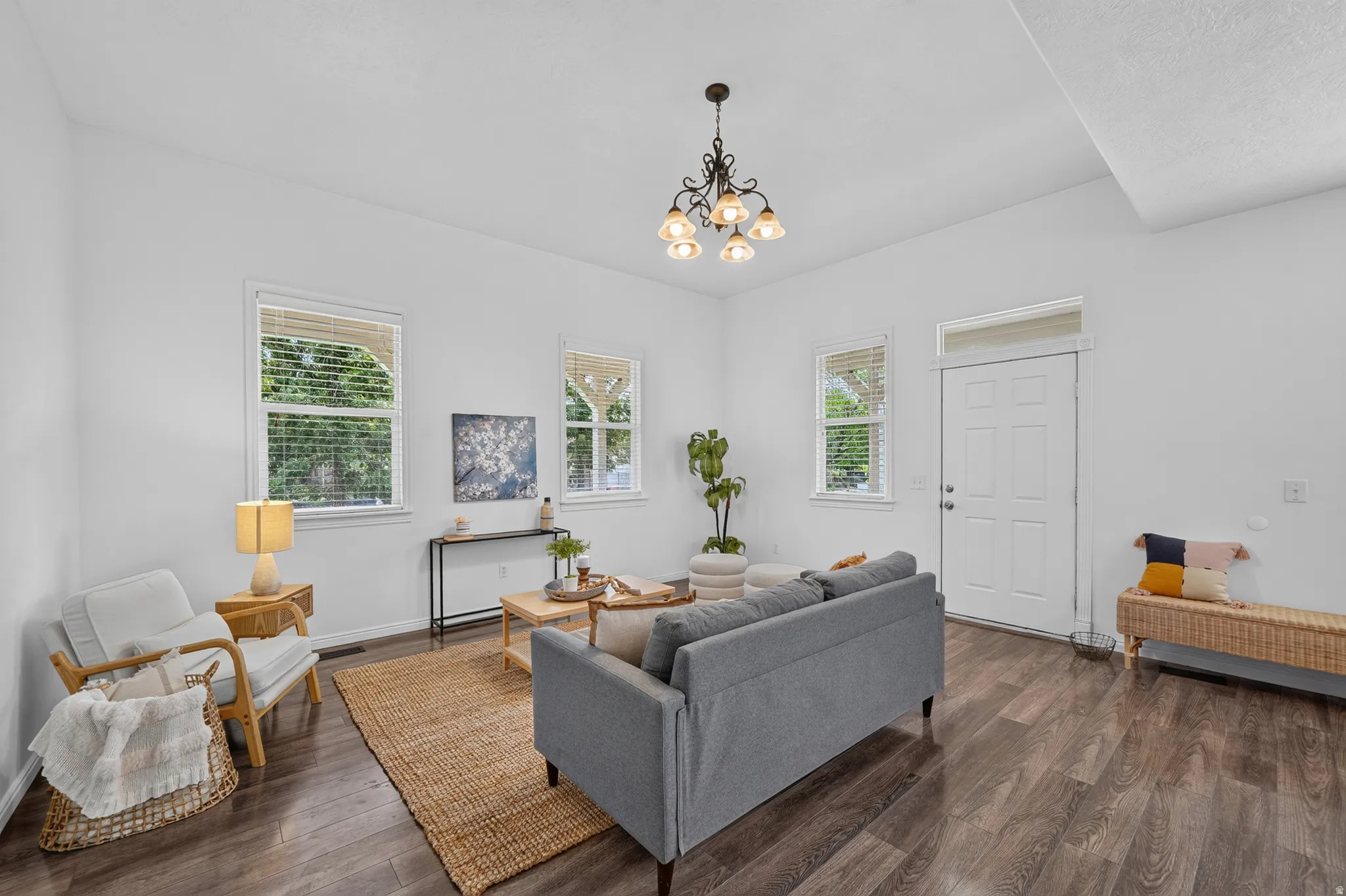 Bright living space featuring wood-finish flooring and multiple windows