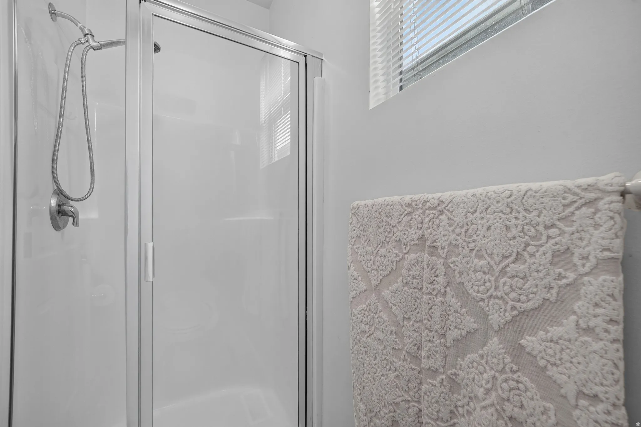 Shower enclosure with an aluminum frame and clear glass door