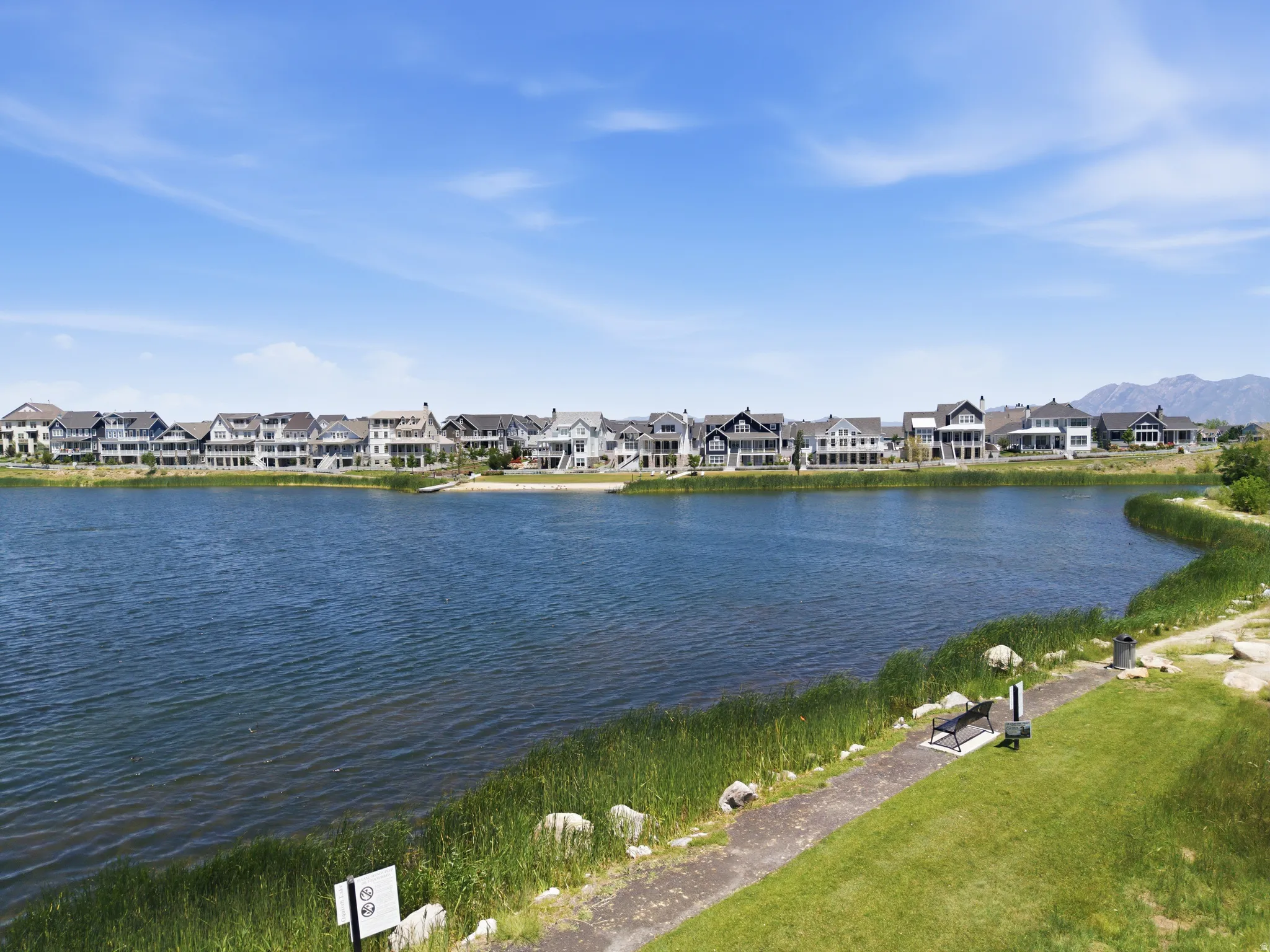 Waterfront homes featuring diverse architectural styles and mature landscaping